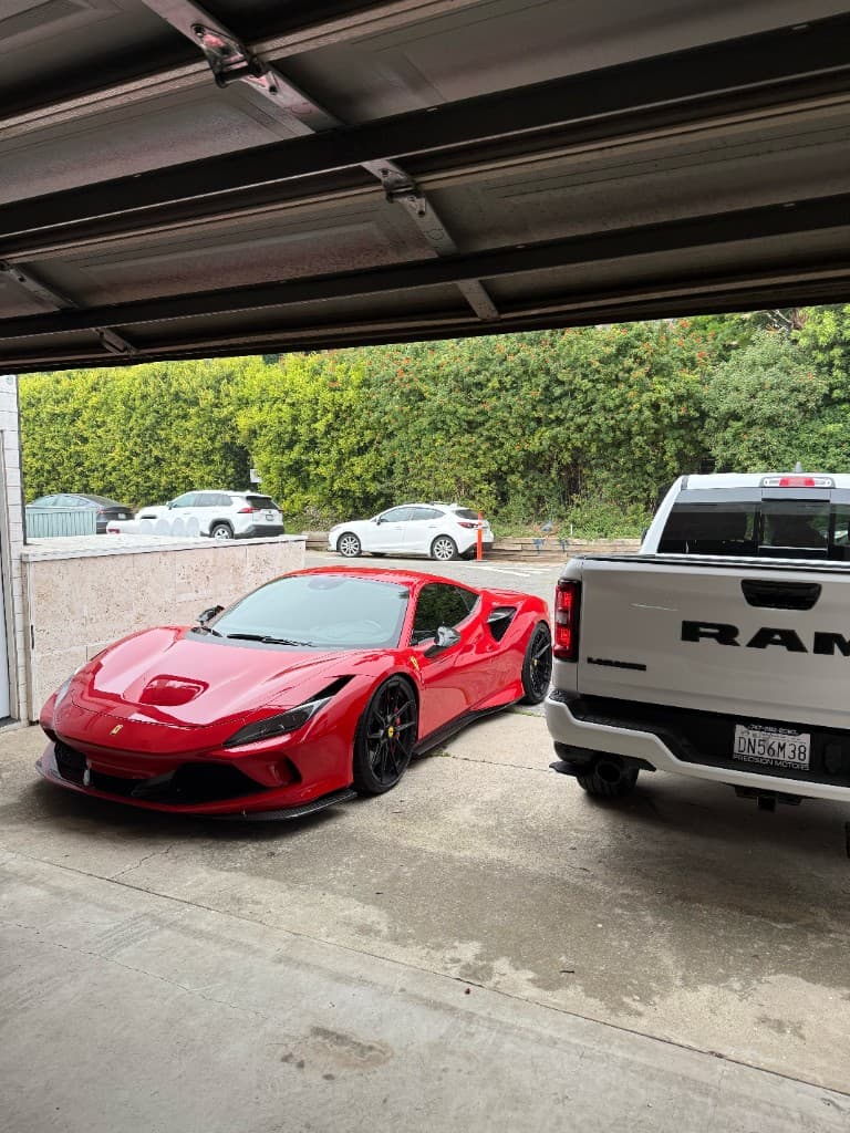 Red Ferrari F8 Tributo on a driveway after delivery