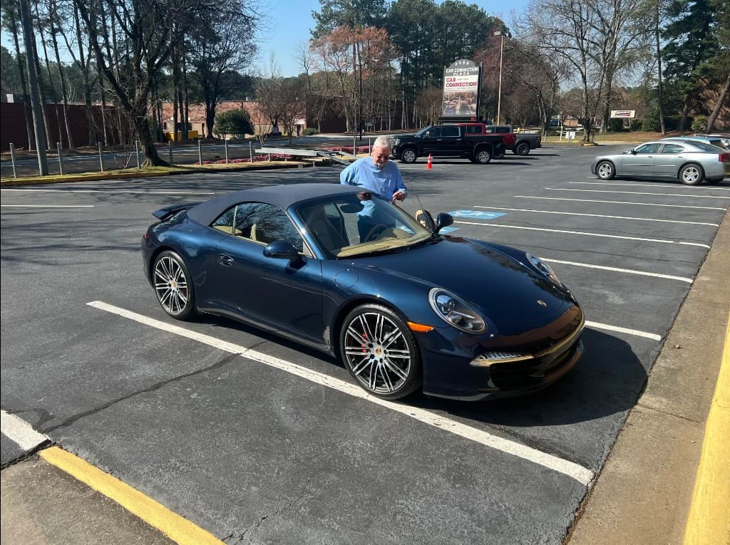 Client with a Porsche 911 Carrera Cabriolet after delivery